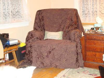 Bethann's recliner in chocolate brocade. We bought this for $10/yd. The walls are painted with Behr's Brazilian Tan (N250-2) Flat finish